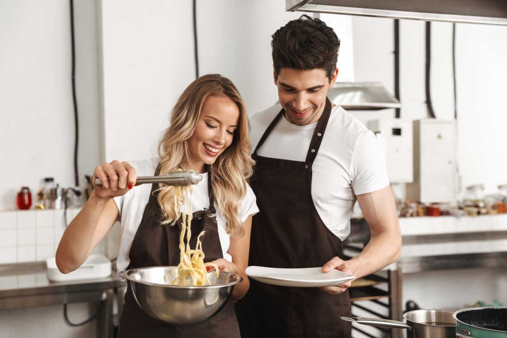 Romantic date cooking class - a couple cooking together