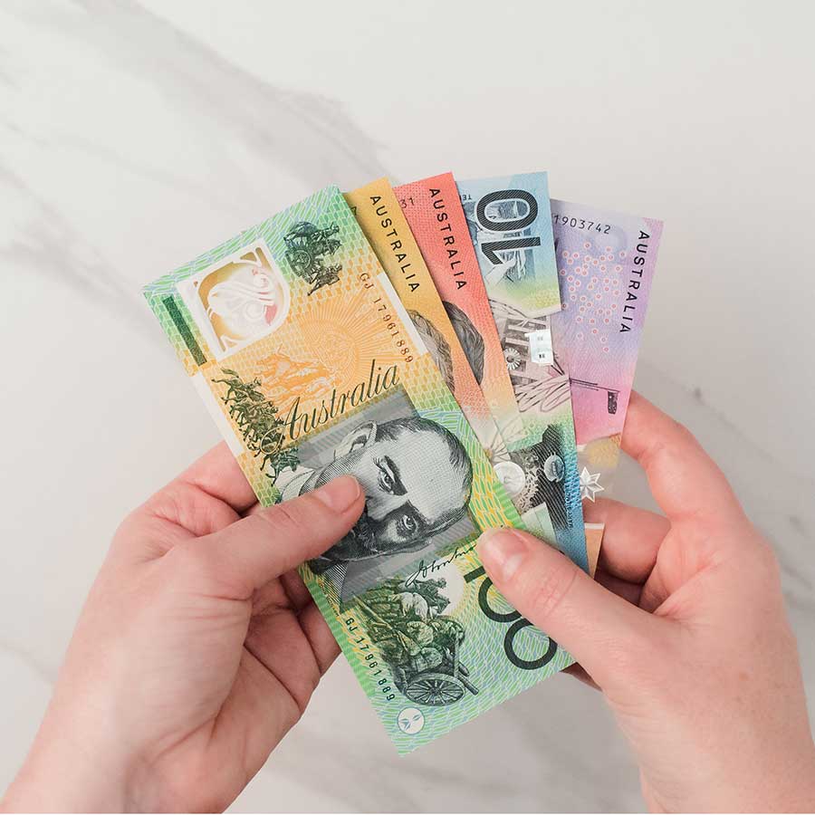 Hands keeping Australian Dollars - budget for the event