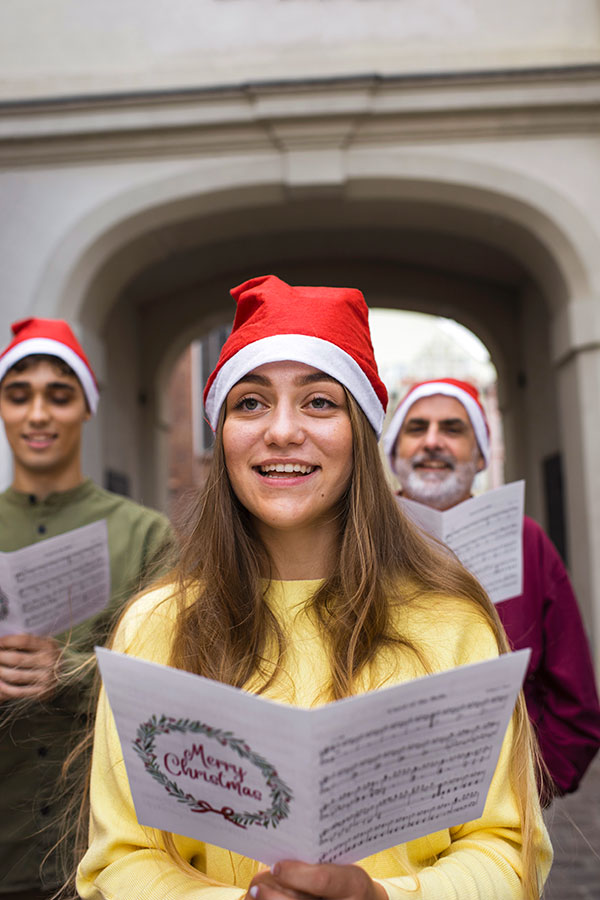 Group of people are singing Christmas carols