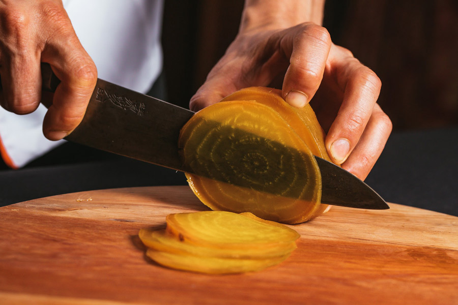 a chef slicing beettroot