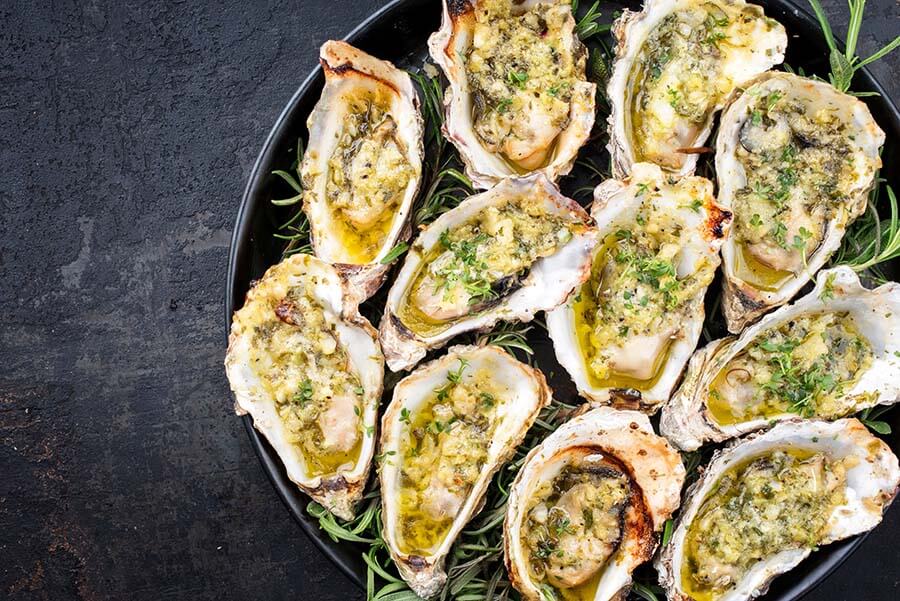 Barbecue overbaked fresh opened oyster with garlic and herbs