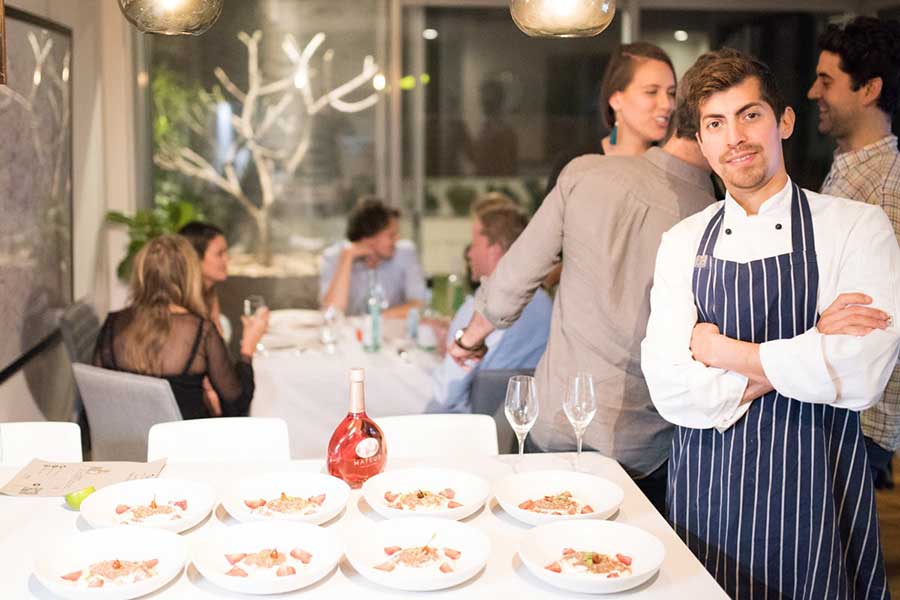 chef Robert Morales in front of a dinner group