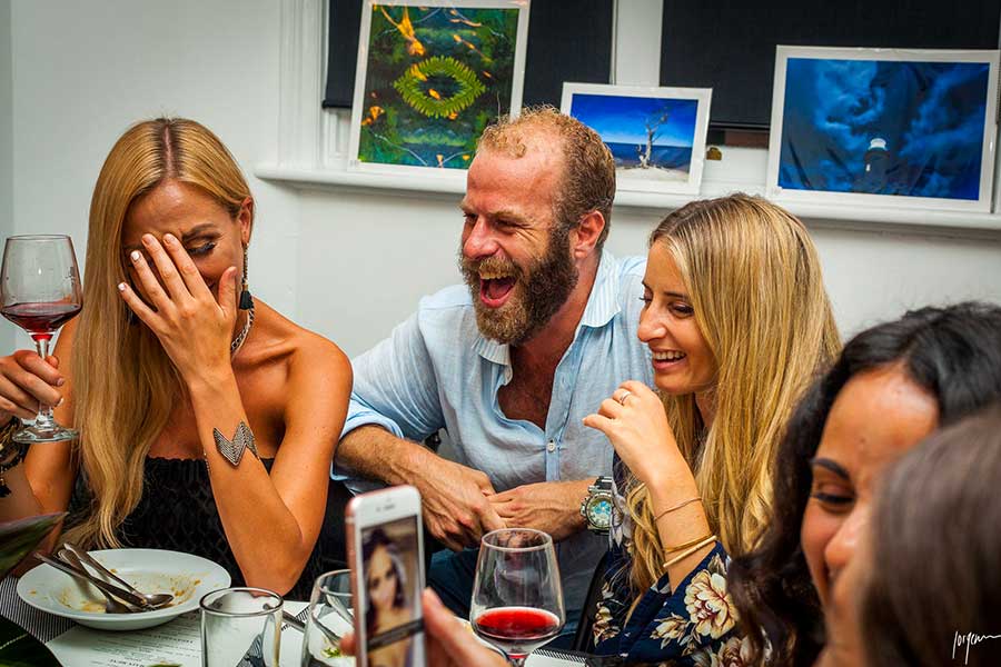 friends-having-a-good-laugh-on-a-dining-table