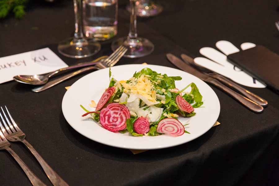 Chef Robert Morales signature vegan salad entree - Radicchio, watermelon reddish, shaved toasted almonds, vegan jus