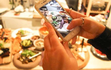 A keen foodie taking a snap with their phone on Sydney North Shore Private Chef Valeria Boselli vegan creations