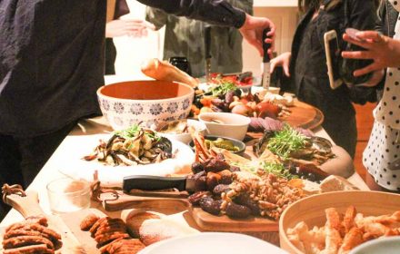 Chef Valeria Boselli presenting vegan grazing table with vegan salami, tossed mushrooms, vegan antipasti, dried fruits & pickles