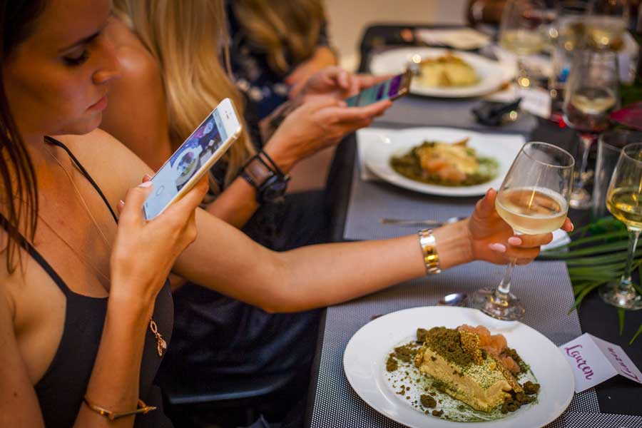 a girl is taking photos at a private dinner party