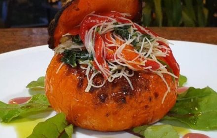 Chef Redouane Belbaz Vegetarian Golden Nugget Pumpkin Containing Roast Nugget Pumpkin filled with vemicelli spinach mushrooms roast capsicum fresh ginger and pomgranate dressing dish