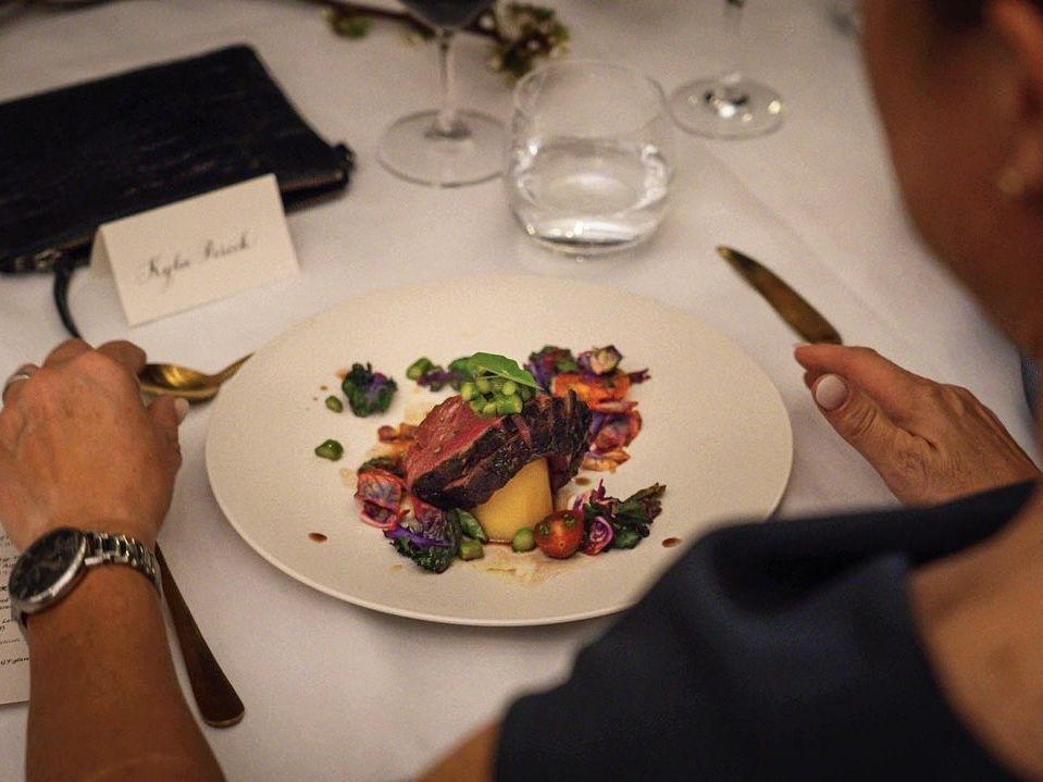 a lady is enjoying a fine dining dish from CHEFIN private chef
