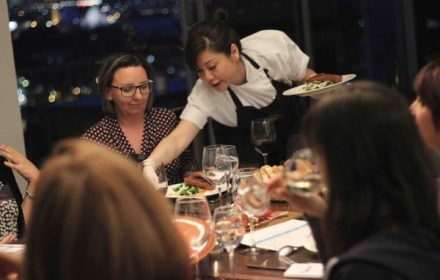 Chef Sasha serving a group of ladies