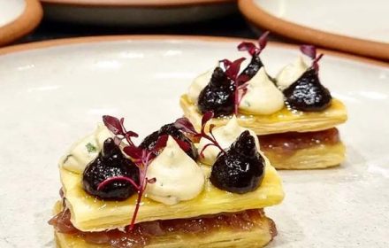 Chef Eloise Riemann Mille Feuille With Caramelised Onions, Pinot Quince, Whipped Pepper Berry Goat Cheese Chive Oil, And Fine Herbs