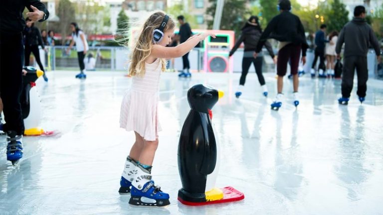 Girl skating with the Penguin toy