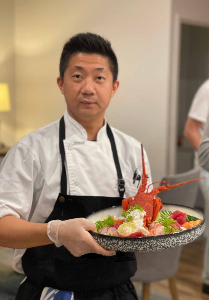 Chent Thant Aung profile photo holding a lobster dish