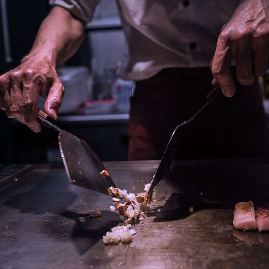 Chef cooking on the grill-plate