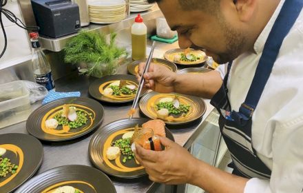 Chef Mani Bharat plating Chef Mani Bharat Poached salmon, fish mousse, lemon butter peas, capers, pickled baby fennel bulb, saffron Bouillabaisse