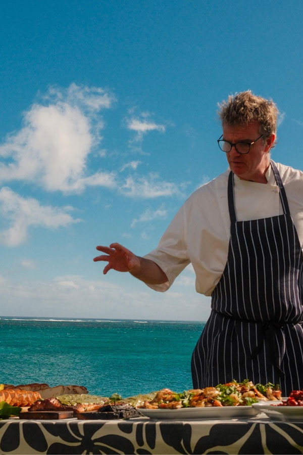 Chef Tom Kime showing a table of food he cooked