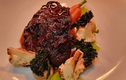 Chef Ziaul Alam Moushi 2 hour red wine braised beef cheek, meltingly tender and glazed in a rich reduction, served with roasted baby carrot and cauliflower, caramelised onion purée, and crisp kale chips