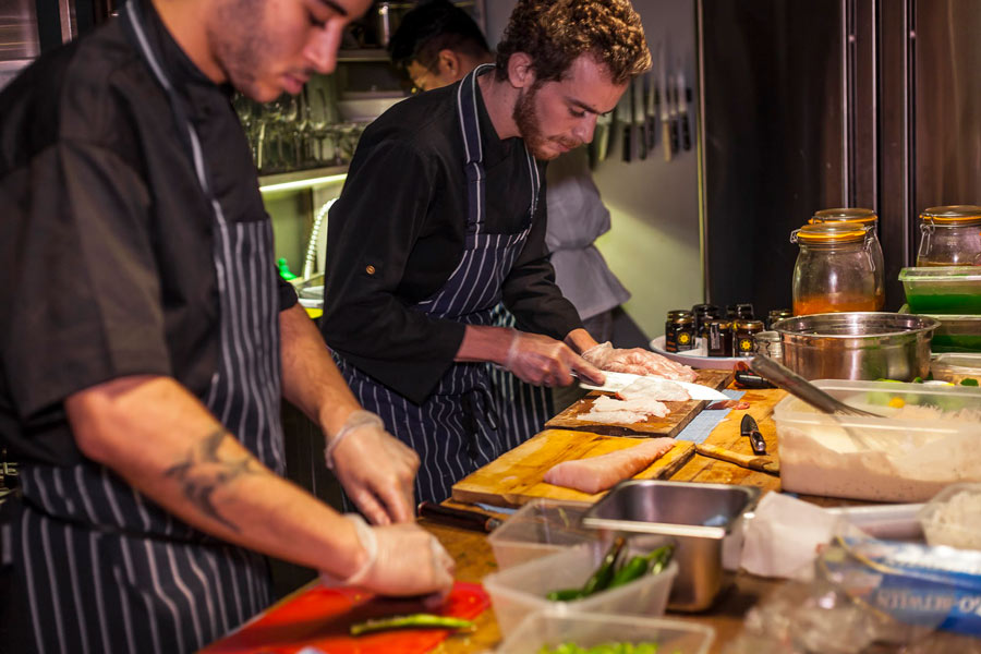 2 private chefs working on fresh ingredients for a private dining function