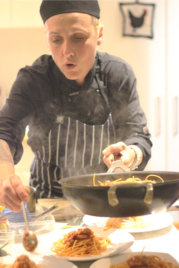 Italian chef Velaria serving pasta