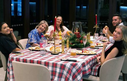 happy guests around christmas table