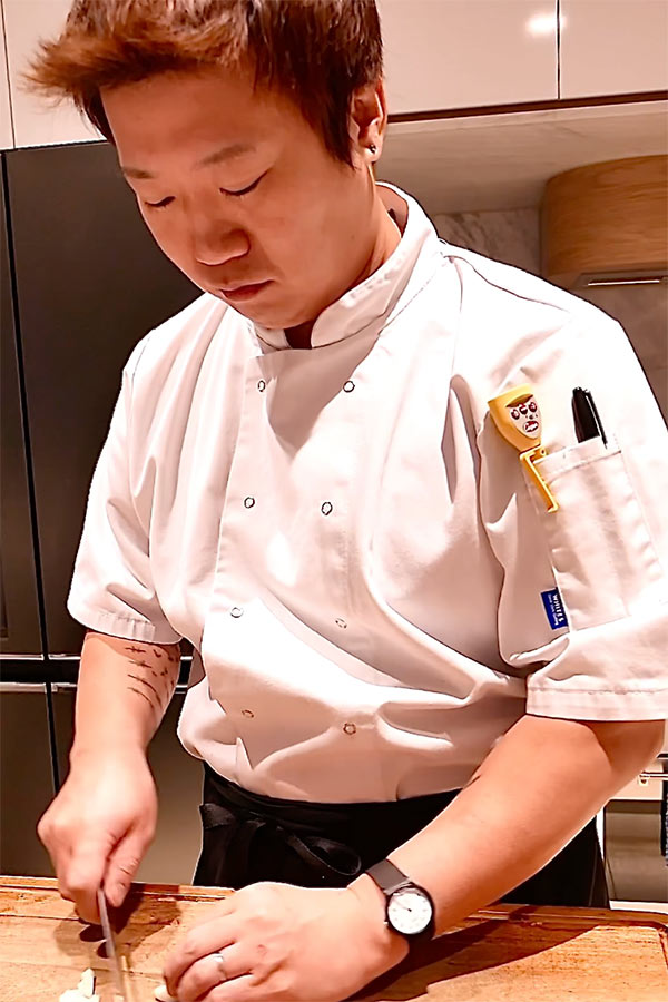 A profile photo of Chef Jay Park cutting during a private event