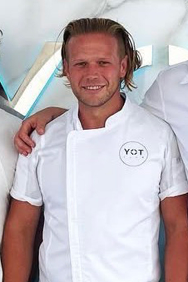 Chef Christopher Holland posingi in chef whites